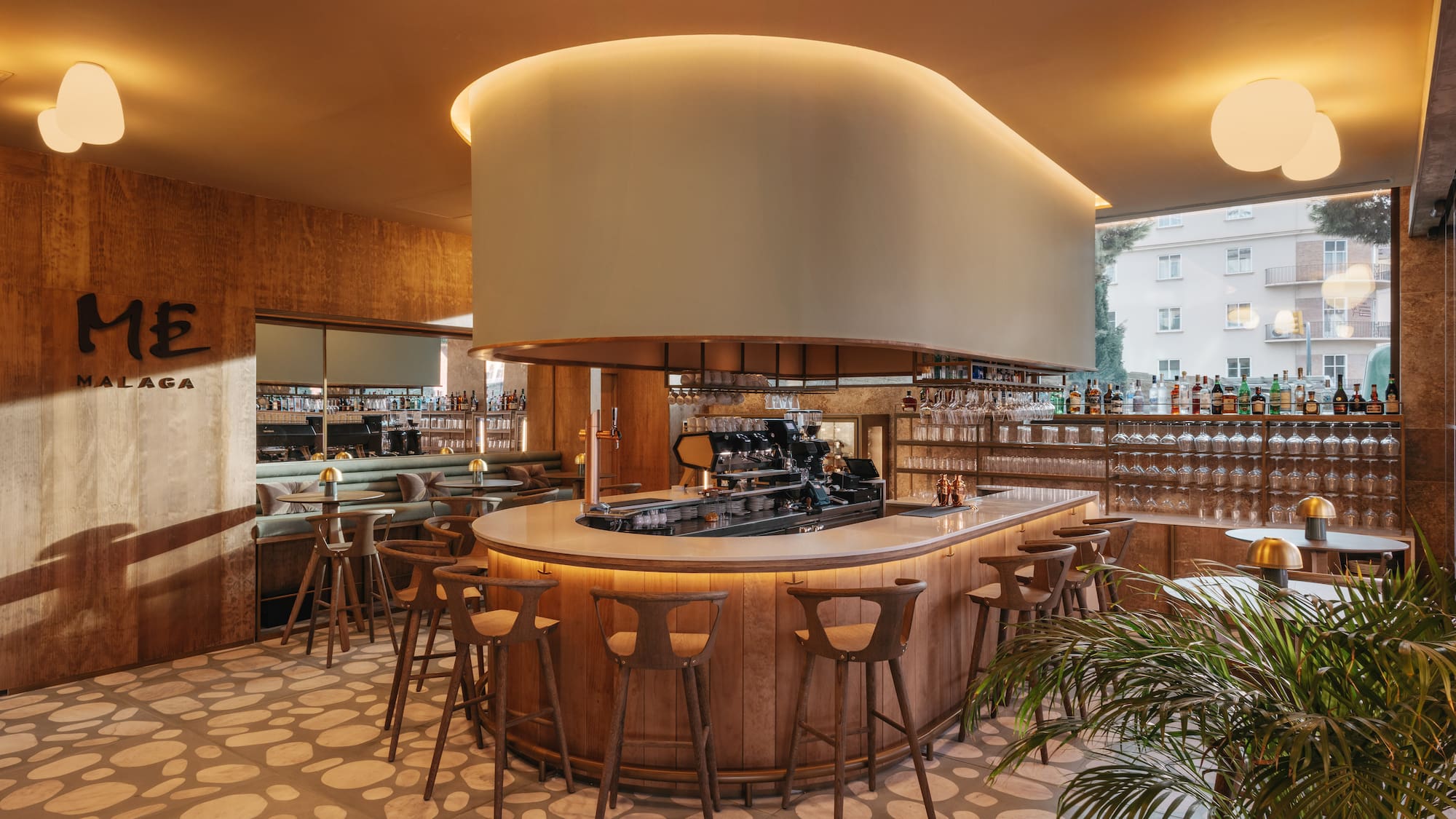 a bar with a large round counter and chairs