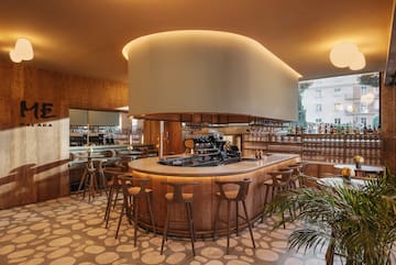 a bar with a large round counter and chairs