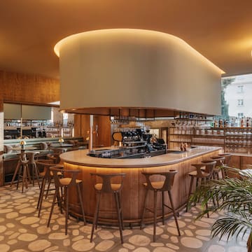 a bar with a large round counter and chairs