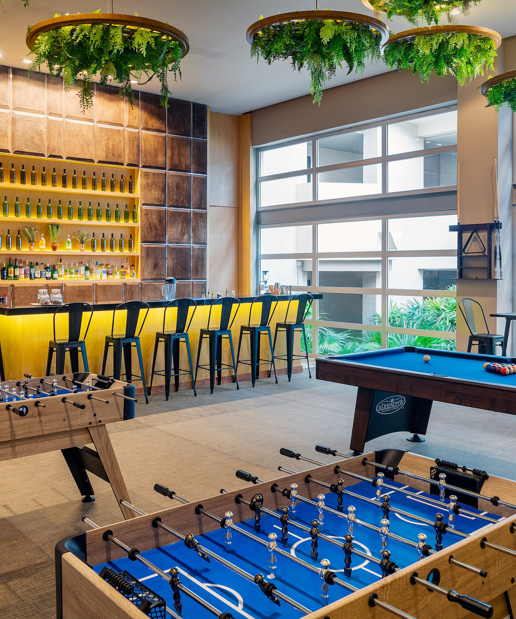 a room with a pool table and bar