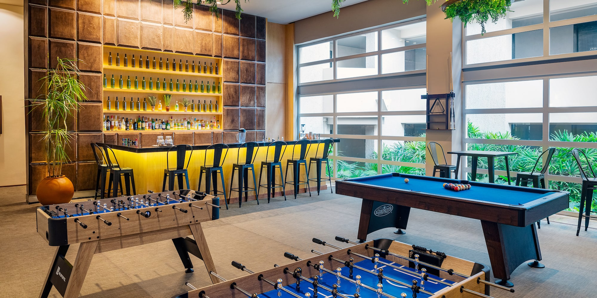 a room with a pool table and bar