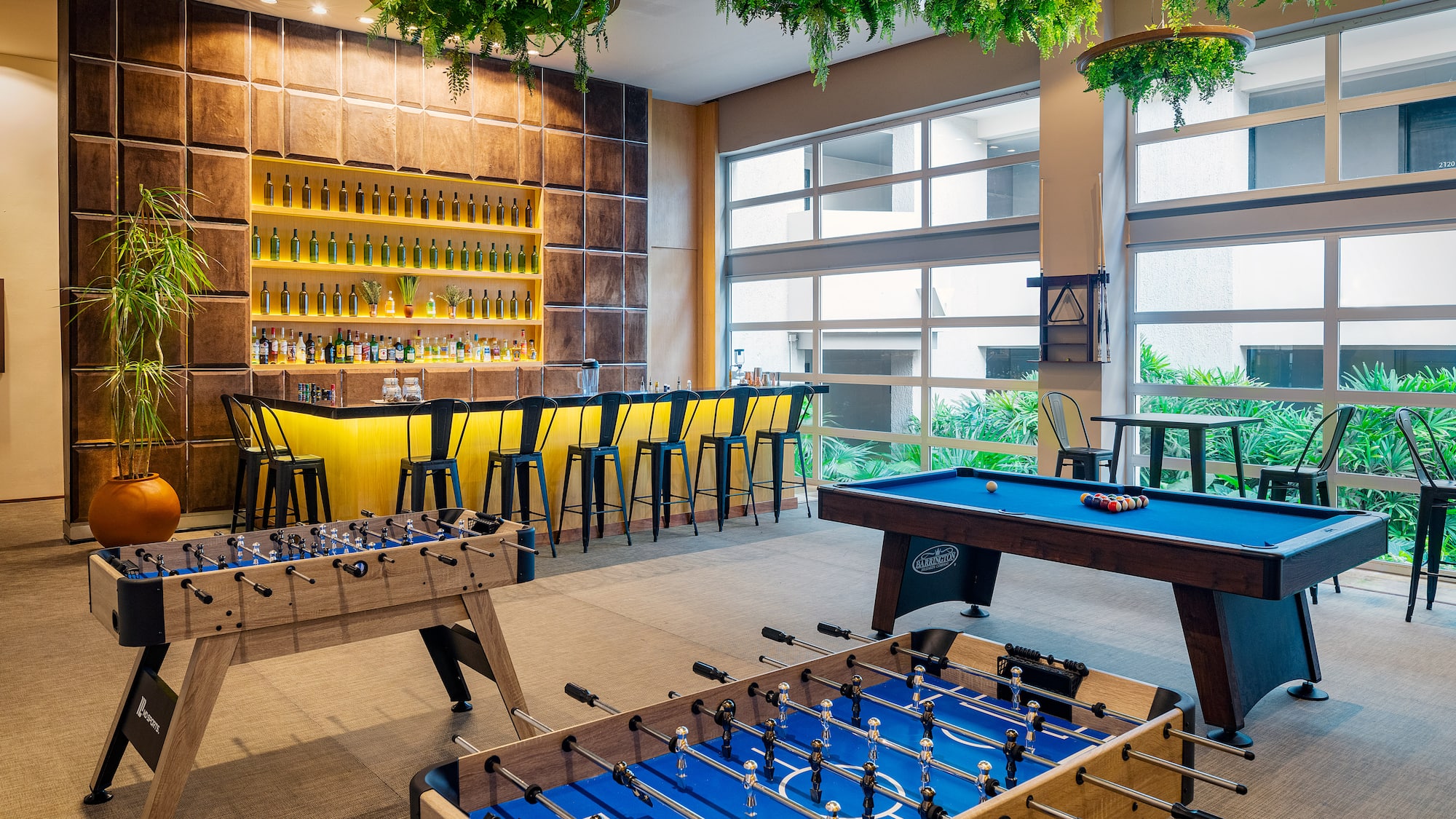 a room with a pool table and bar