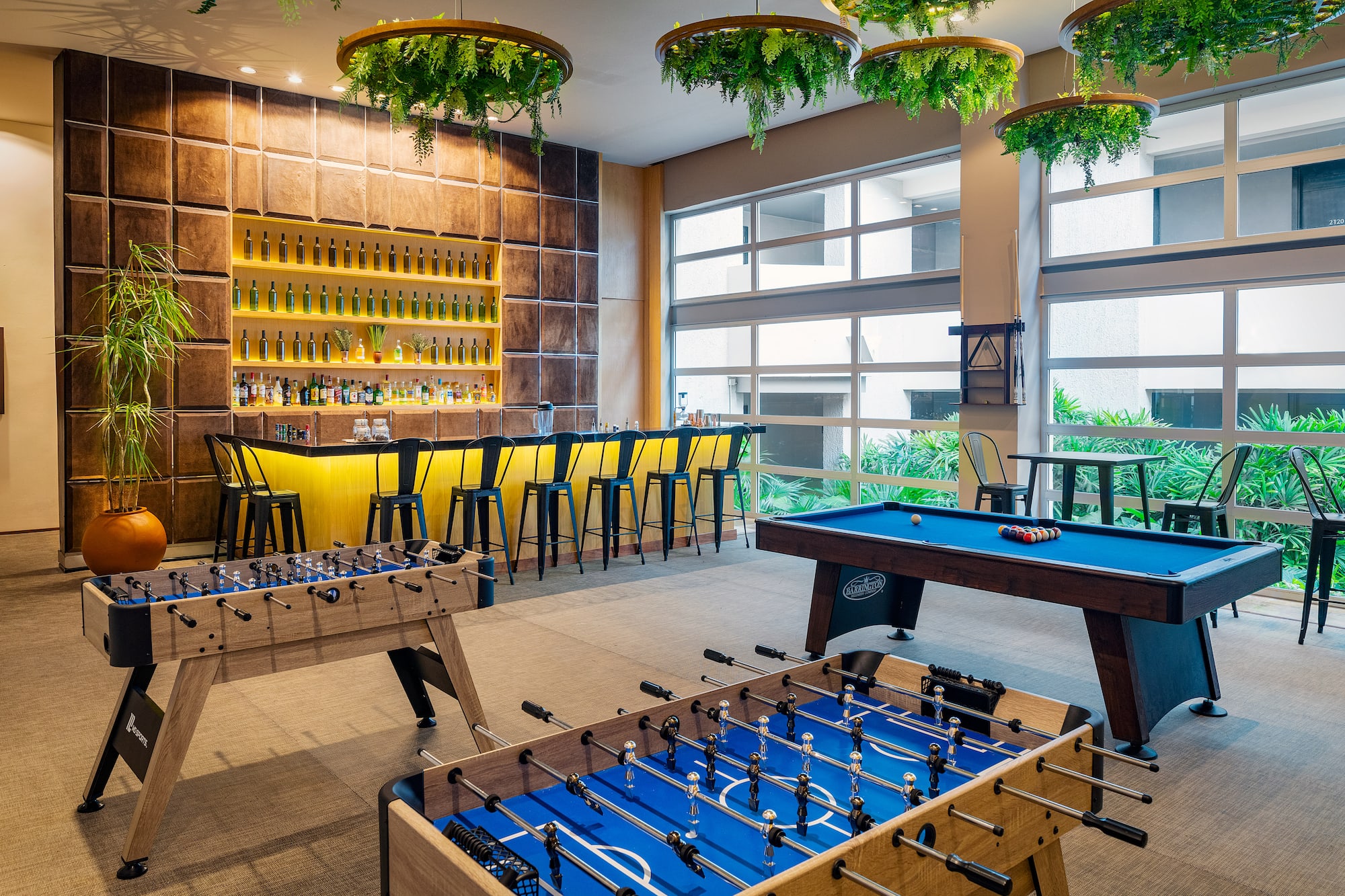 a room with a pool table and bar