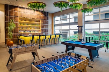a room with a pool table and bar