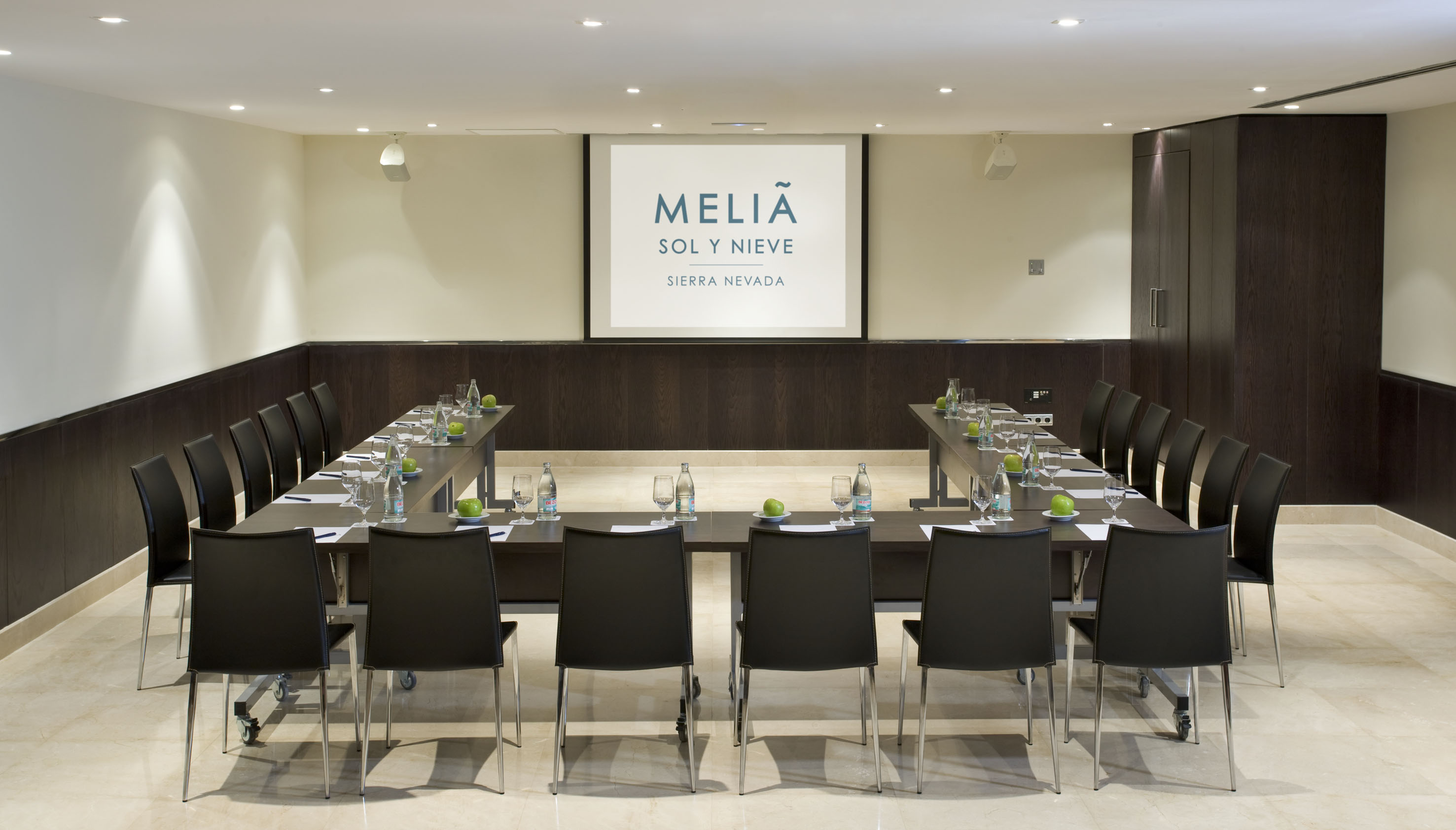 U-shaped conference room at Meliá Sol y Nieve Sierra Nevada with projector screen.