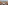Resort balcony with seating, ocean view, palm trees, and boat.
