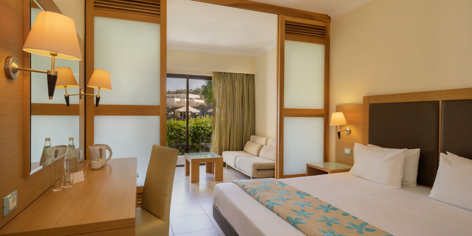 a room with a bed and a table and chairs