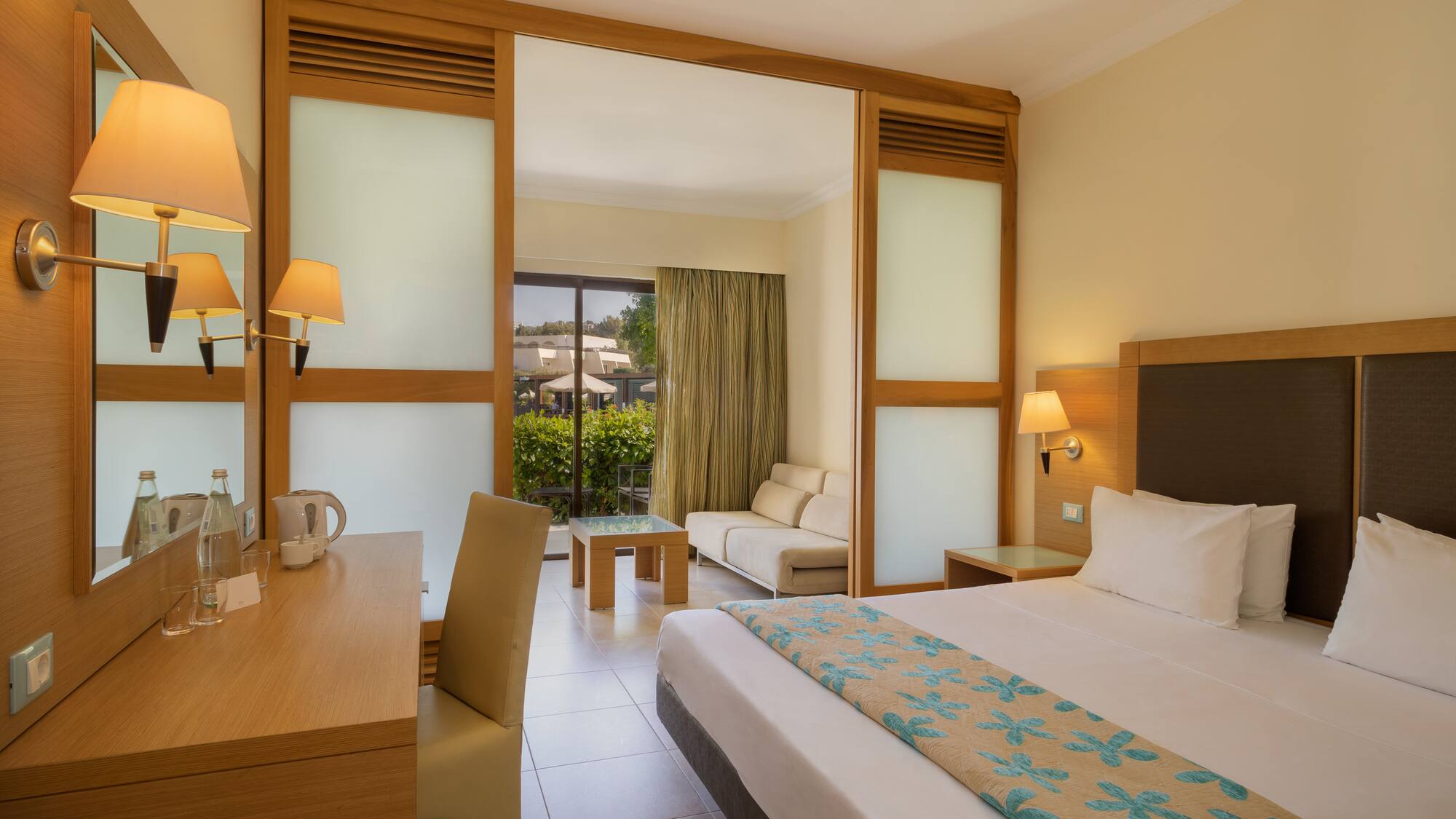 a room with a bed and a table and chairs