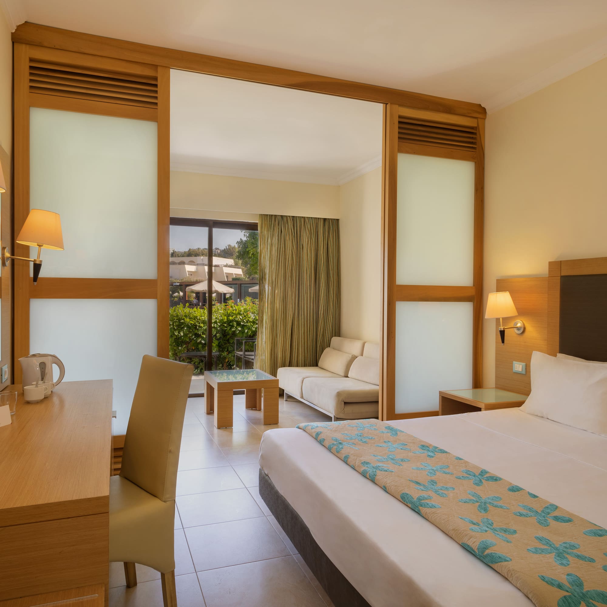 a room with a bed and a table and chairs