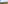 Desert garden with cacti, palm trees, dark volcanic soil, and arid mountains.