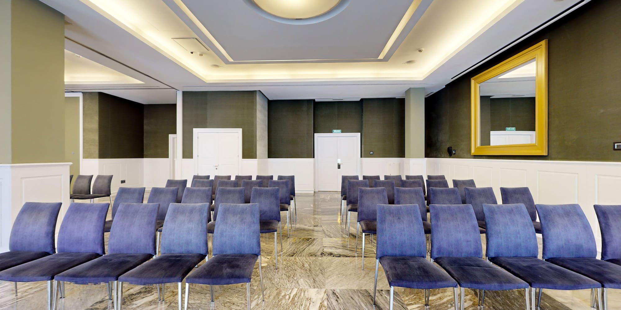 a room with chairs and a mirror