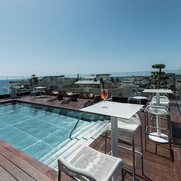 a pool with a table and chairs on a deck