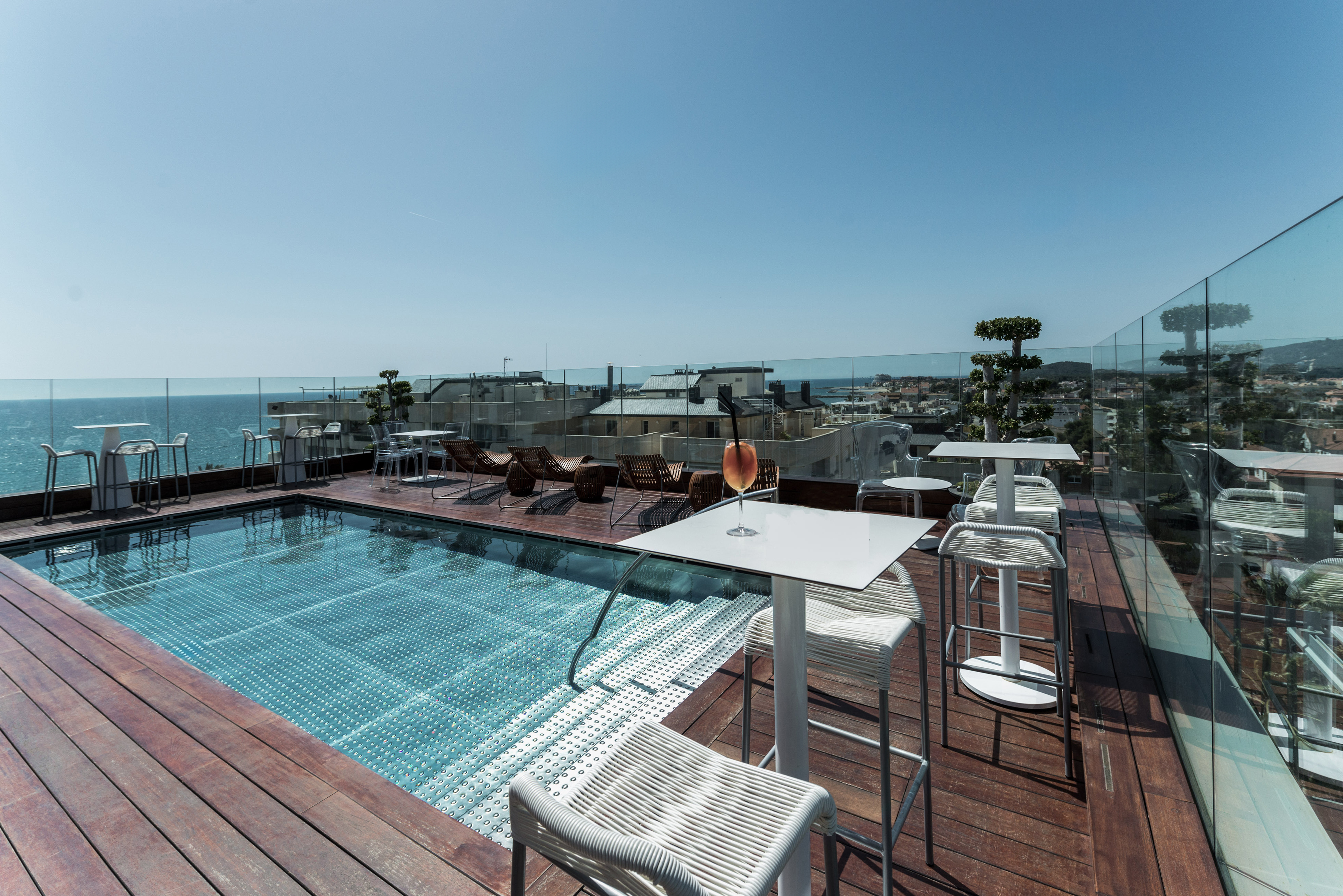 a pool with a table and chairs on a deck
