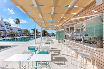 a pool with tables and chairs