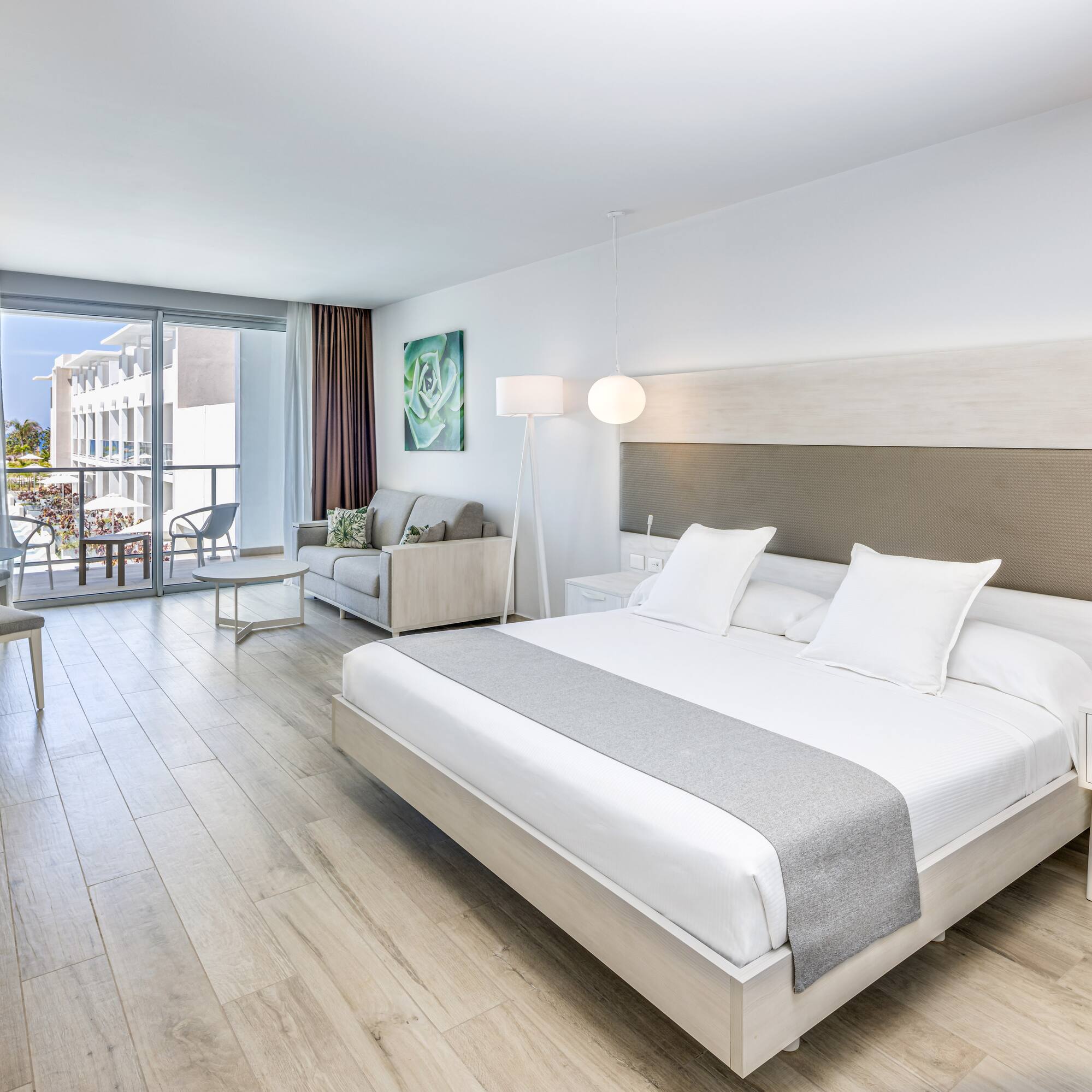 a bedroom with a large bed and a wood floor