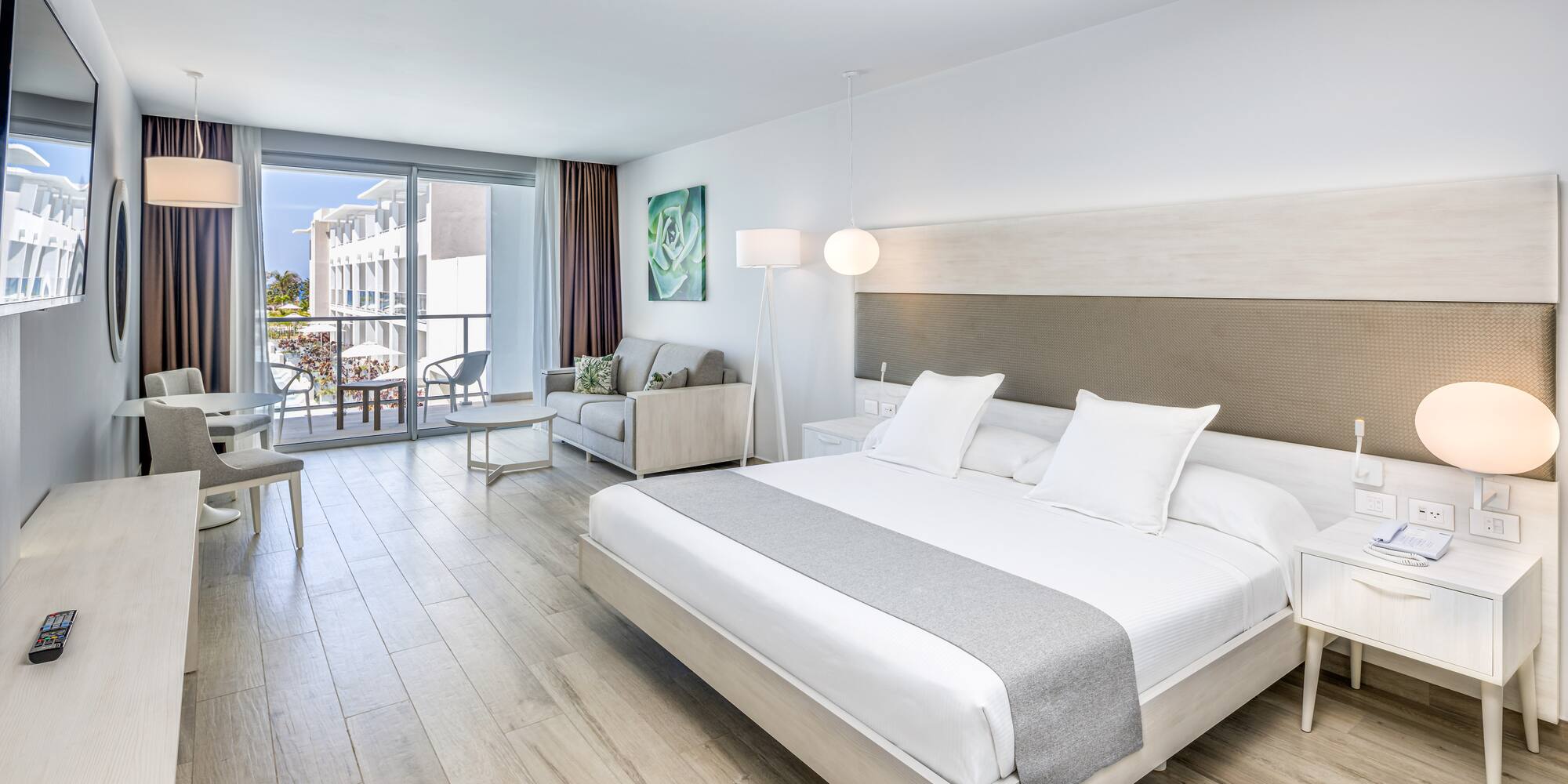 a bedroom with a large bed and a wood floor