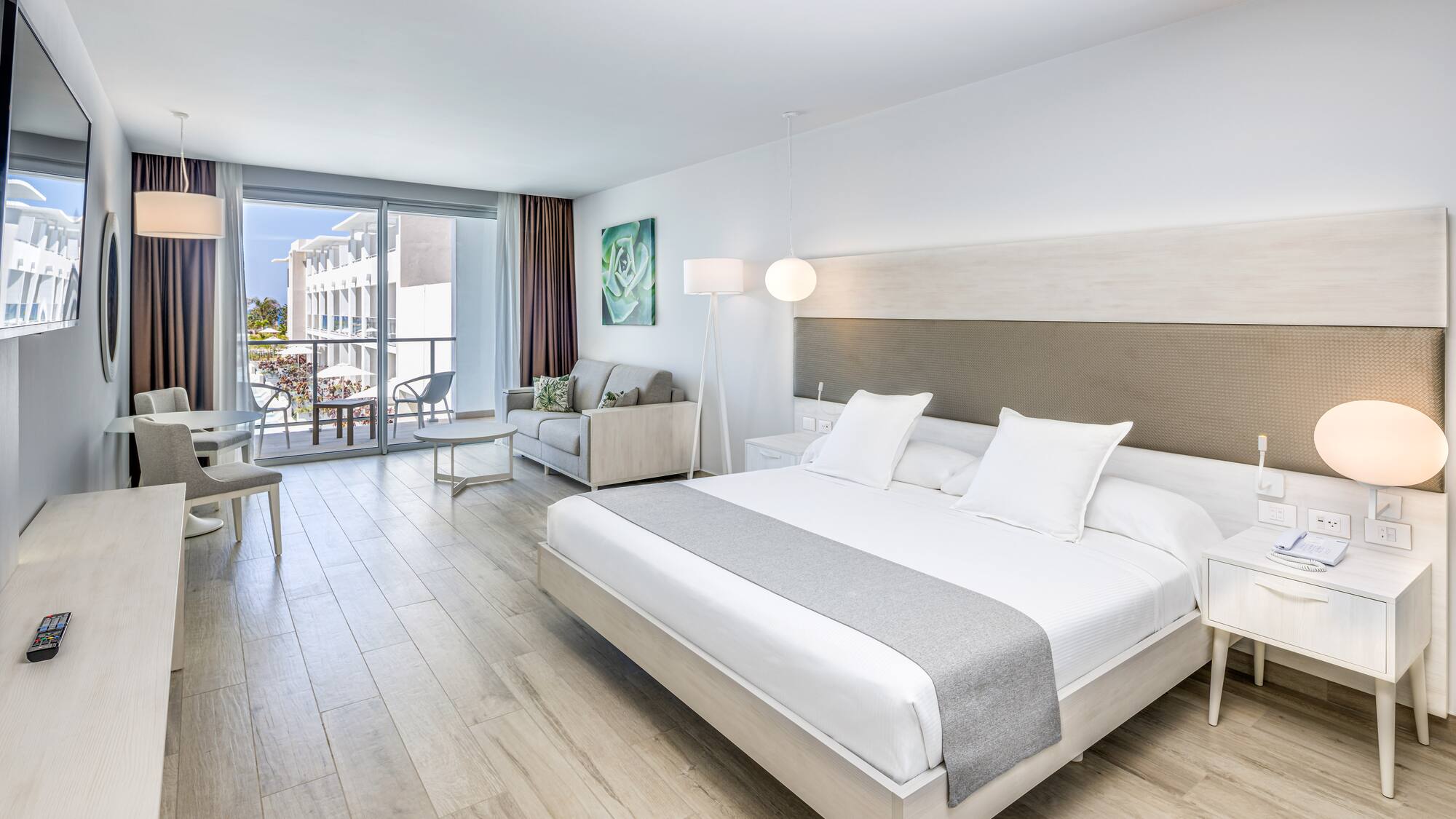 a bedroom with a large bed and a wood floor