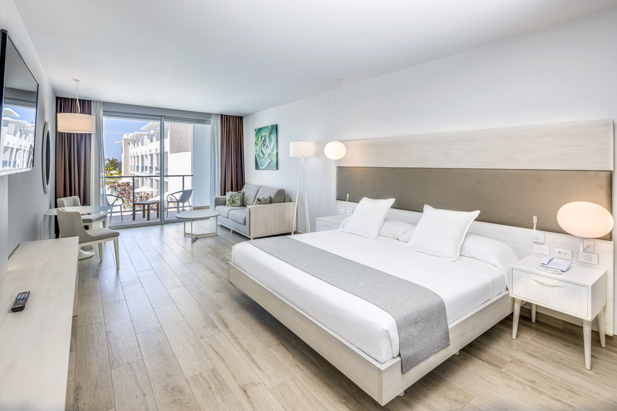 a bedroom with a large bed and a wood floor