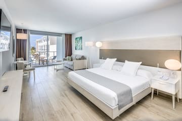 a bedroom with a large bed and a wood floor