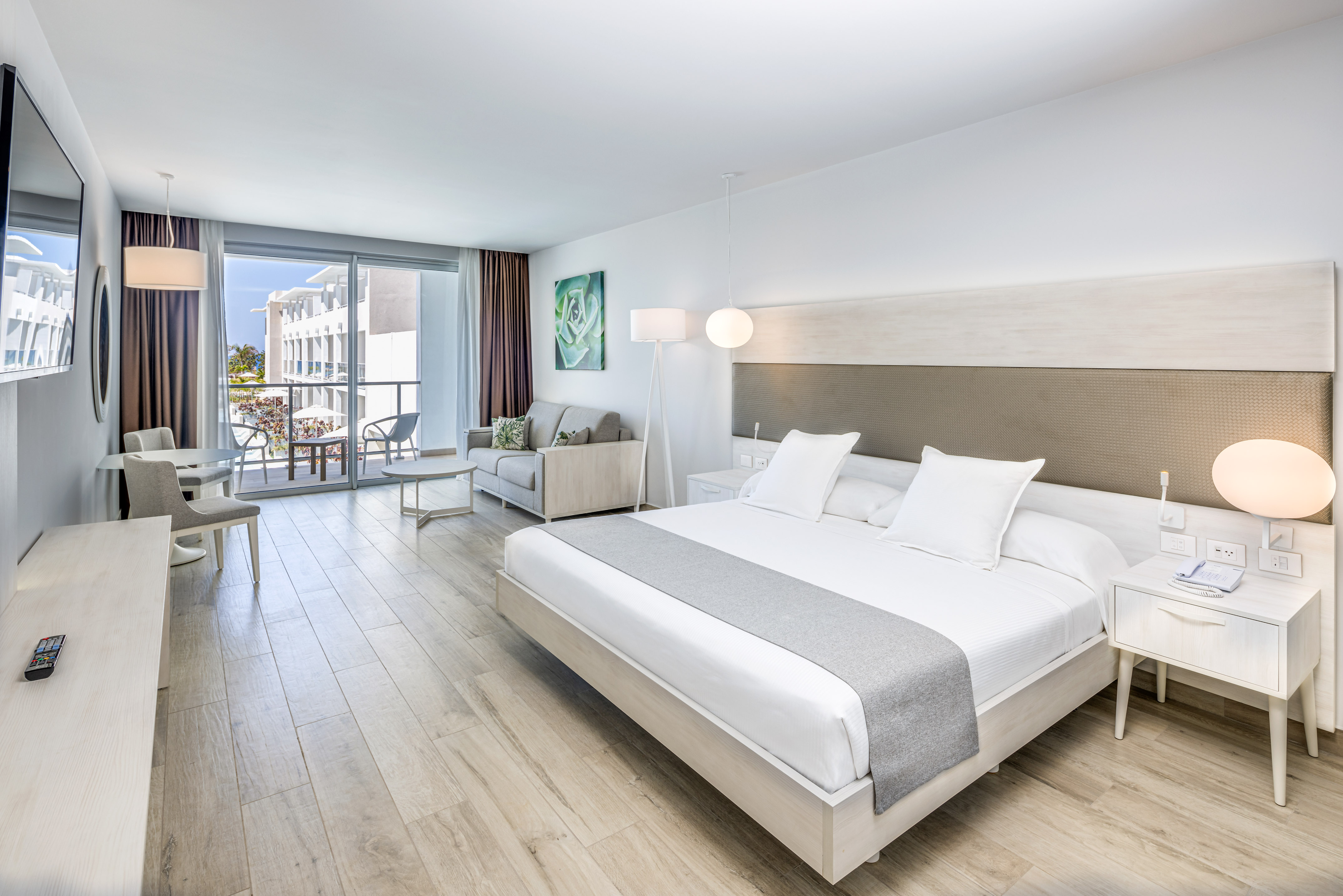 a bedroom with a large bed and a wood floor