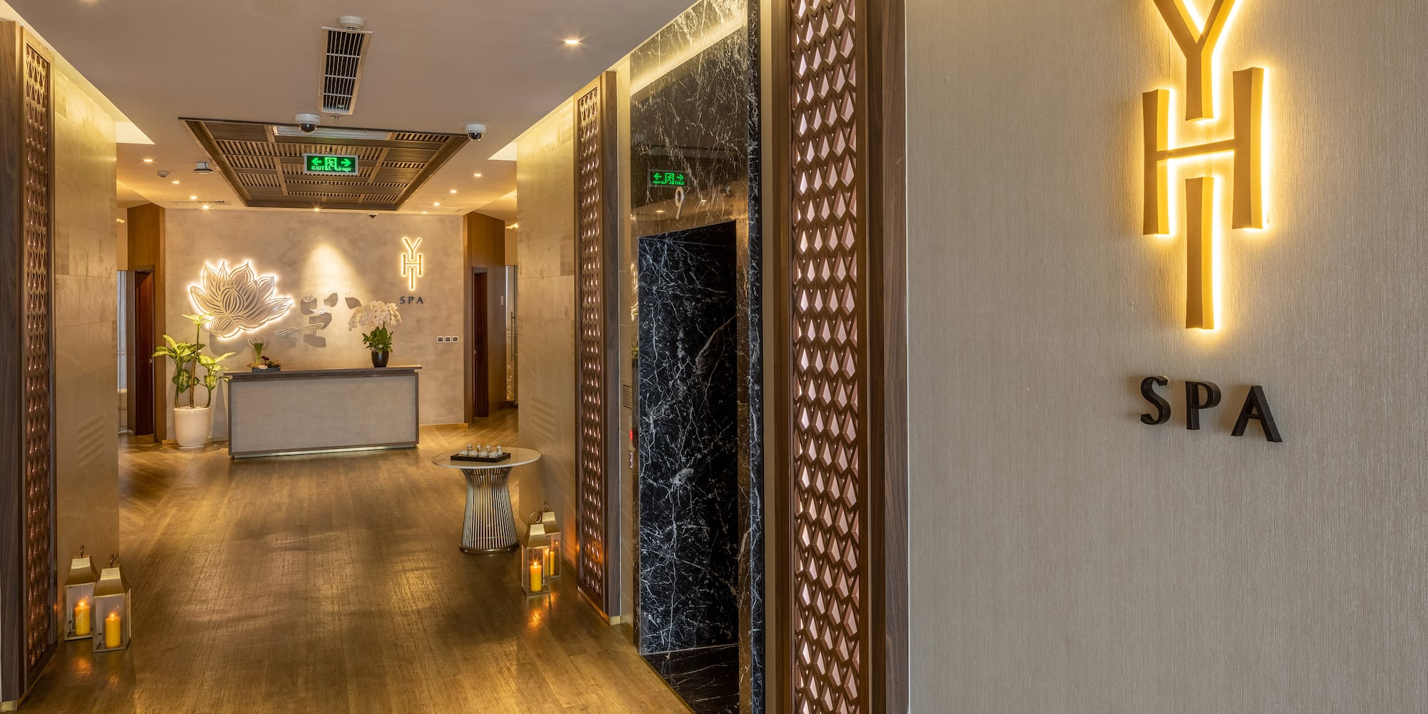 a hallway with a sign and a reception desk