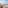 Balcony with ocean view, lounge chair, table, and arid coastal landscape.