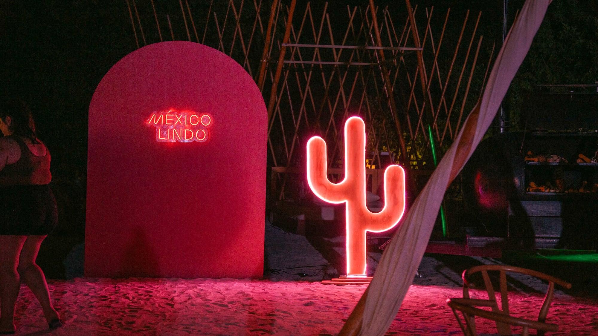 a neon sign next to a red sign