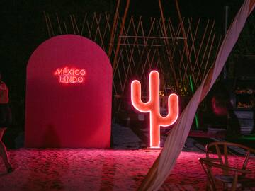 a neon sign next to a red sign