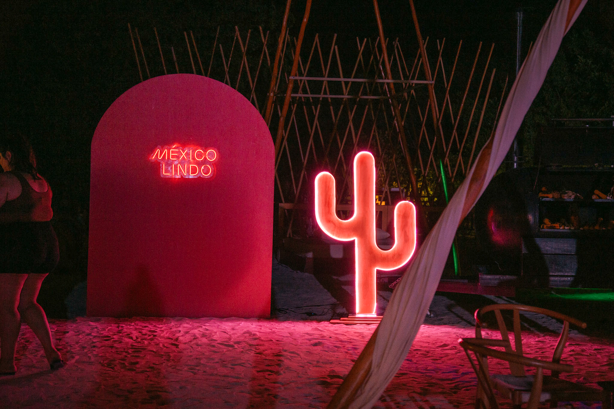 a neon sign next to a red sign