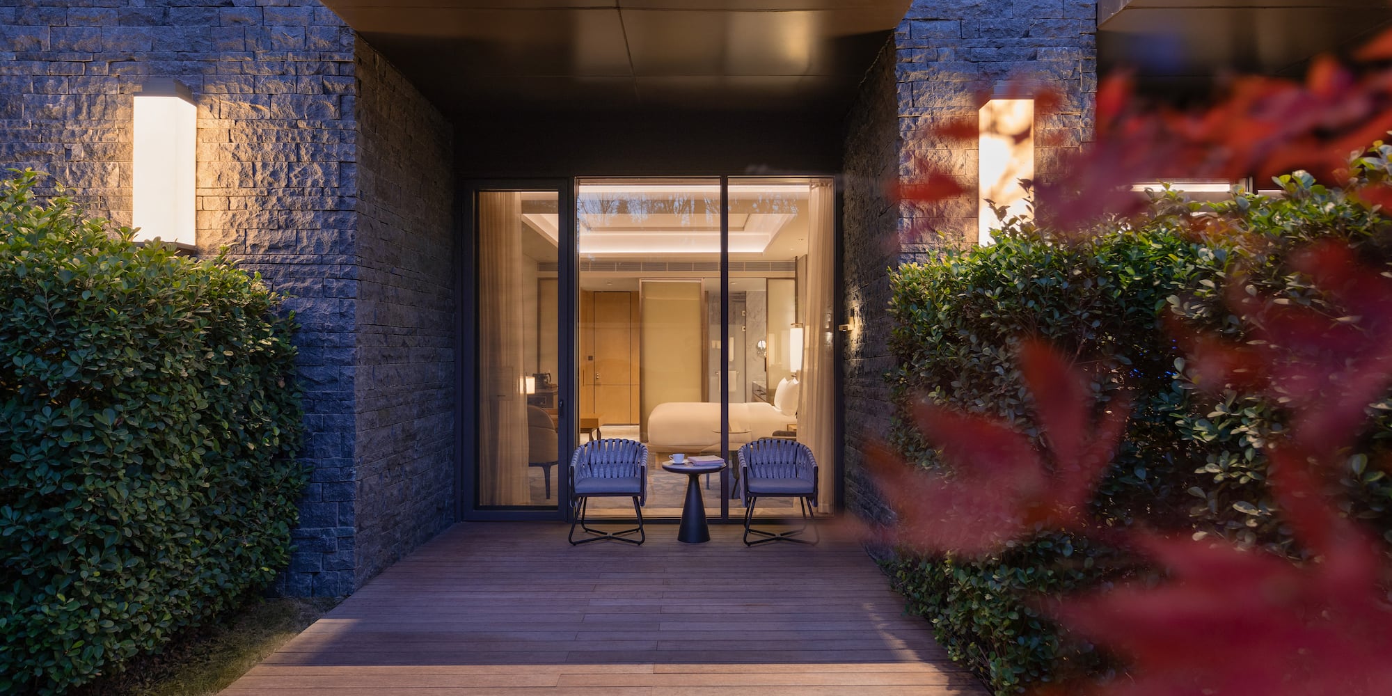 a patio with chairs and a table in front of a building