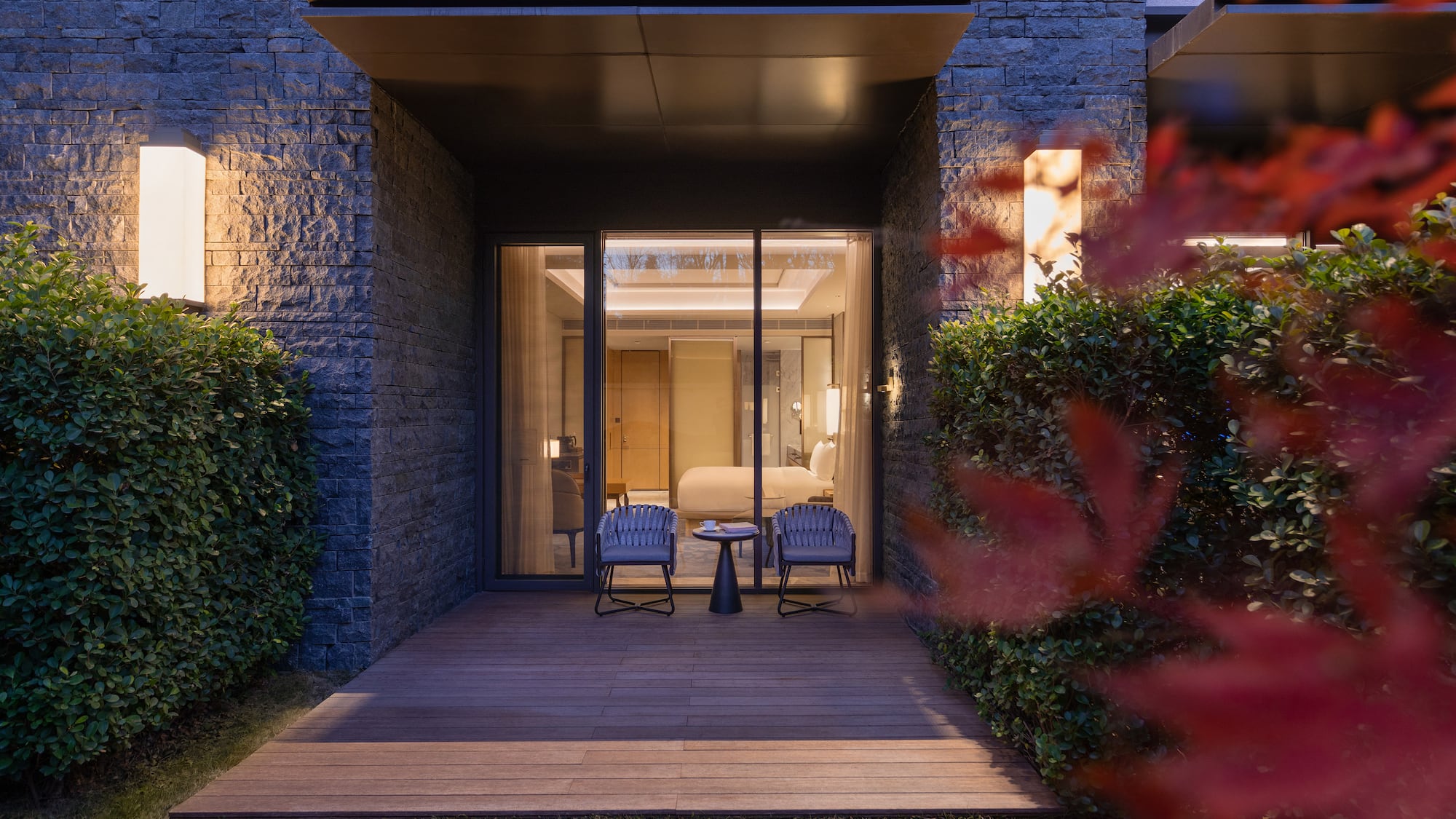 a patio with chairs and a table in front of a building