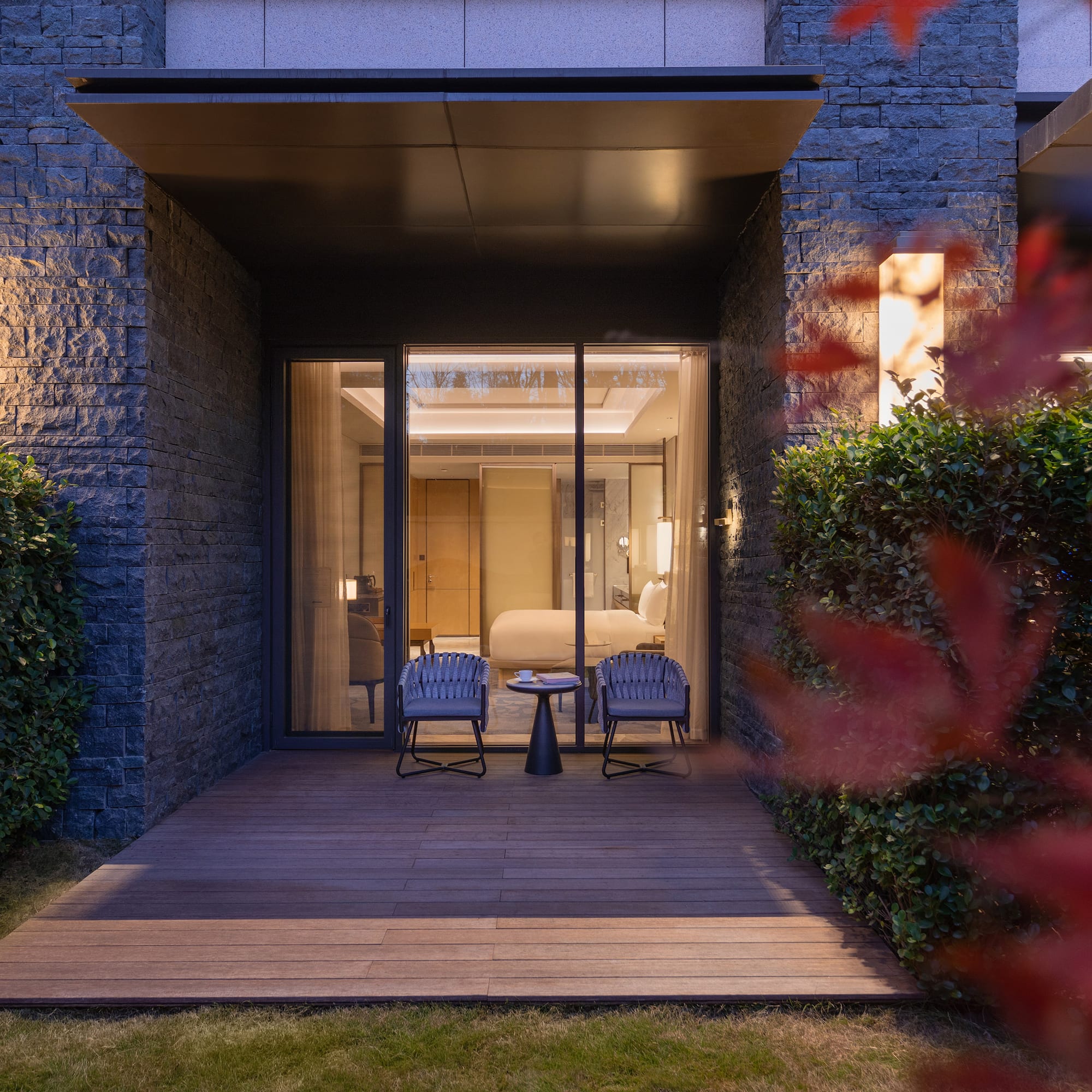 a patio with chairs and a table in front of a building