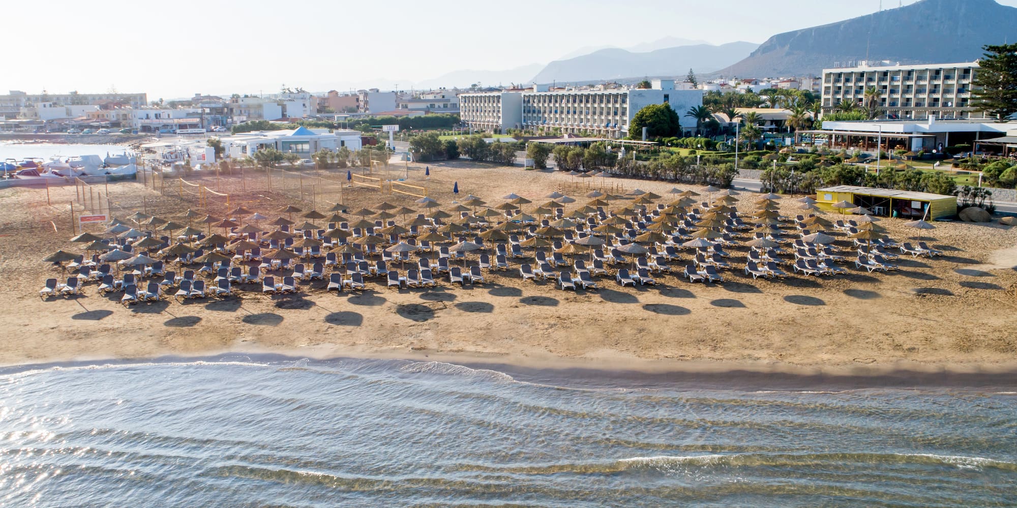 a beach with chairs and umbrellas