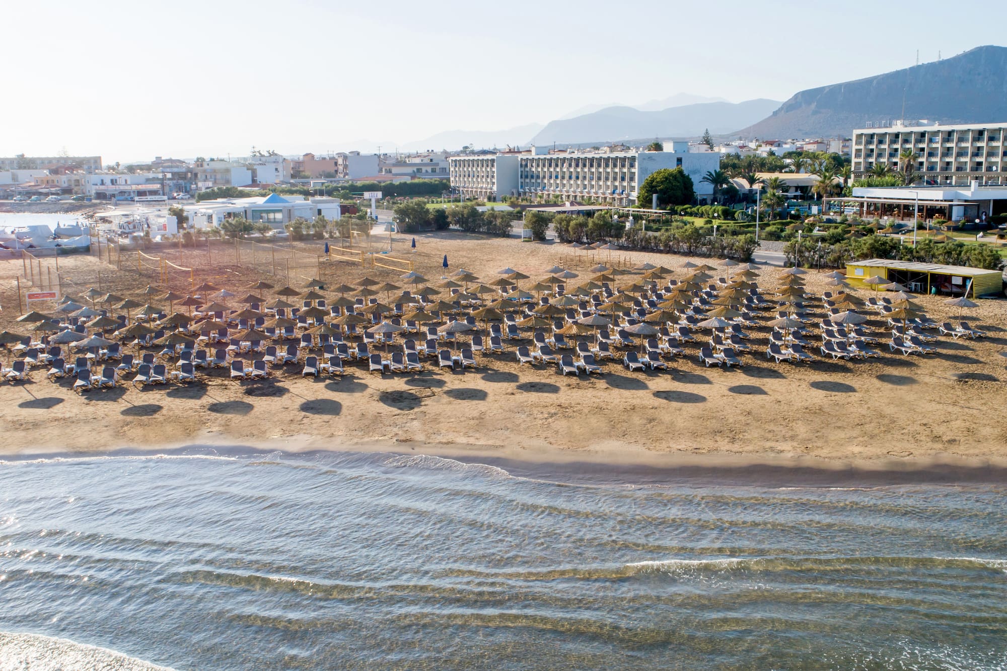 a beach with chairs and umbrellas