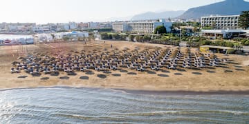 a beach with chairs and umbrellas