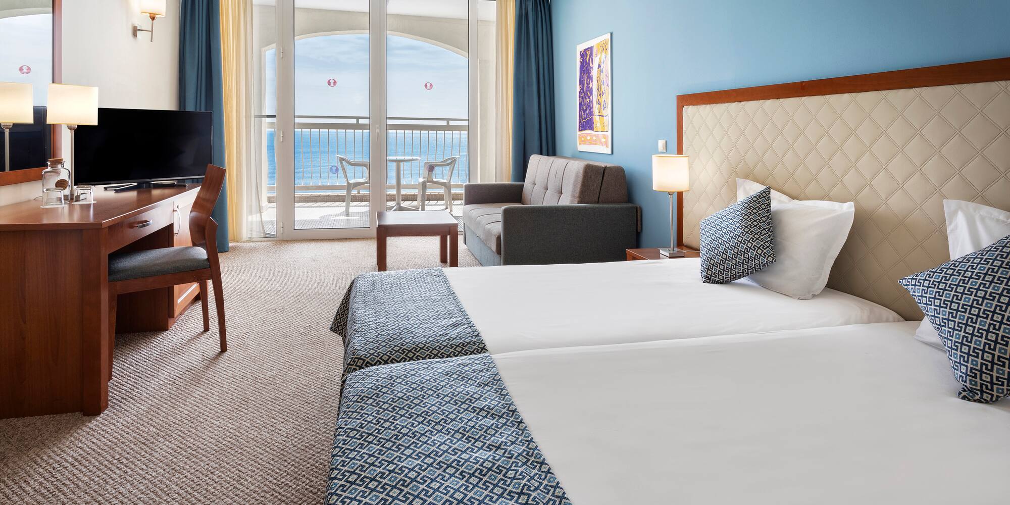 a room with two beds and a television