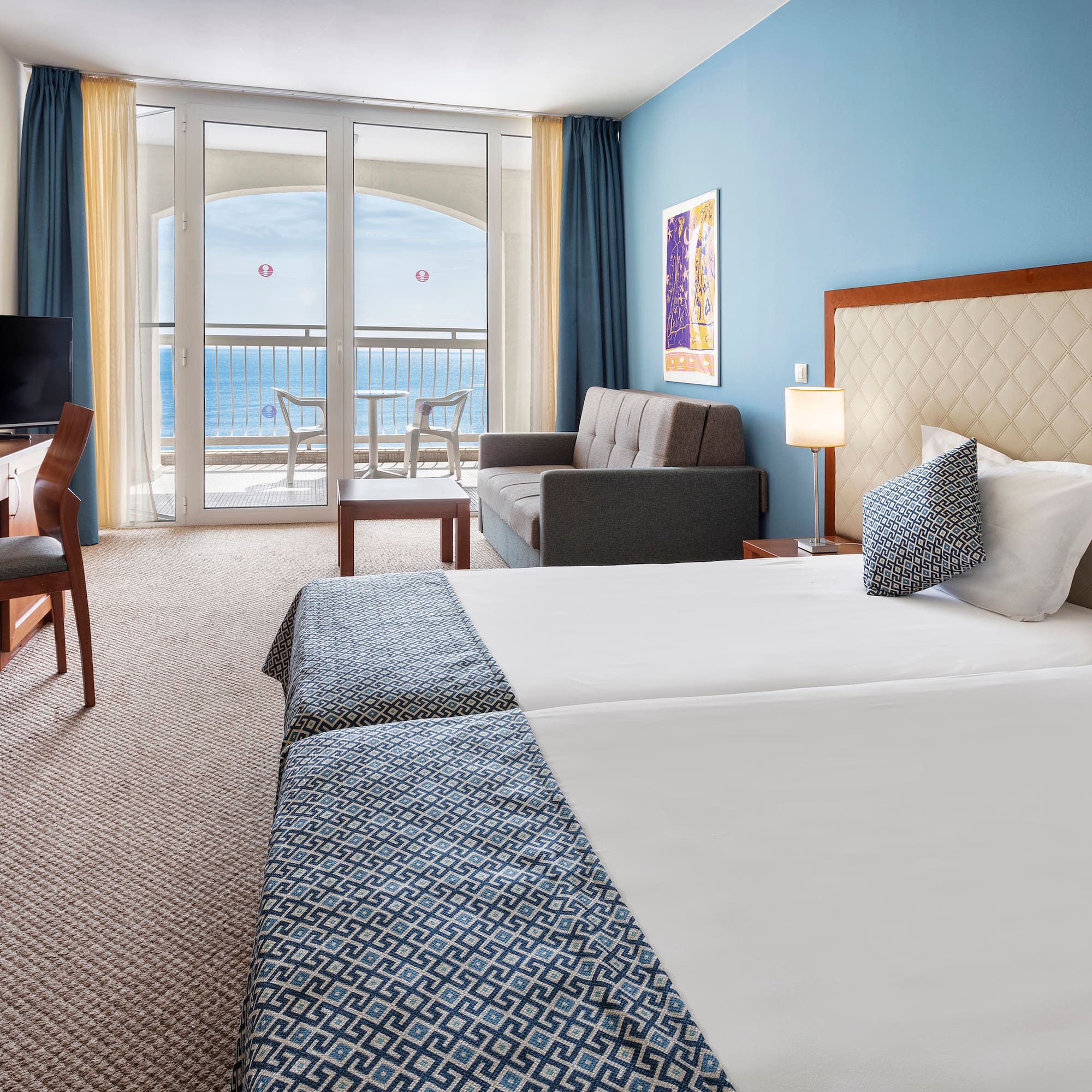 a room with two beds and a television