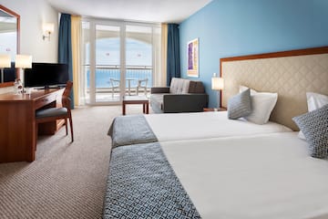 a room with two beds and a television