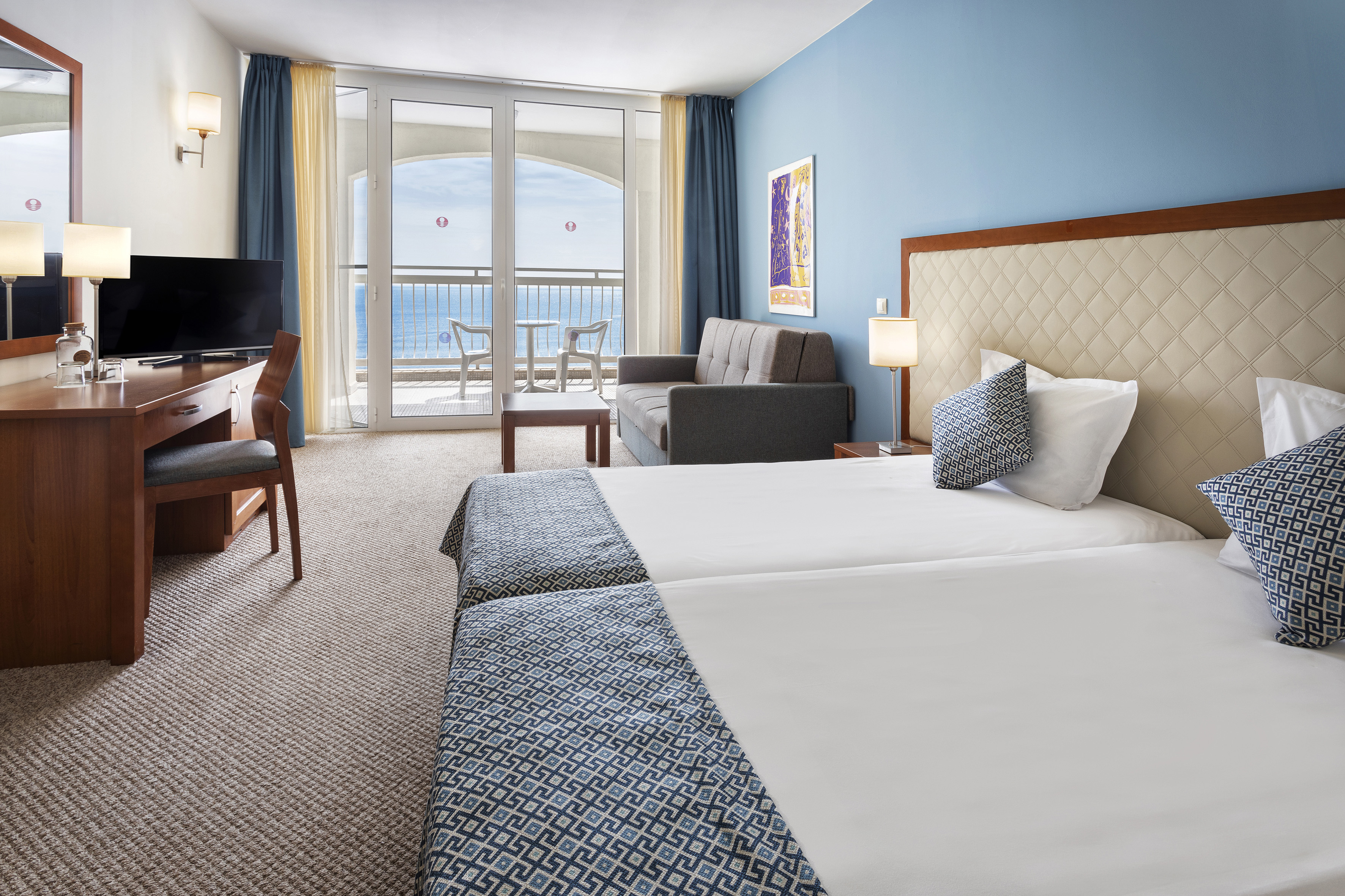 a room with two beds and a television