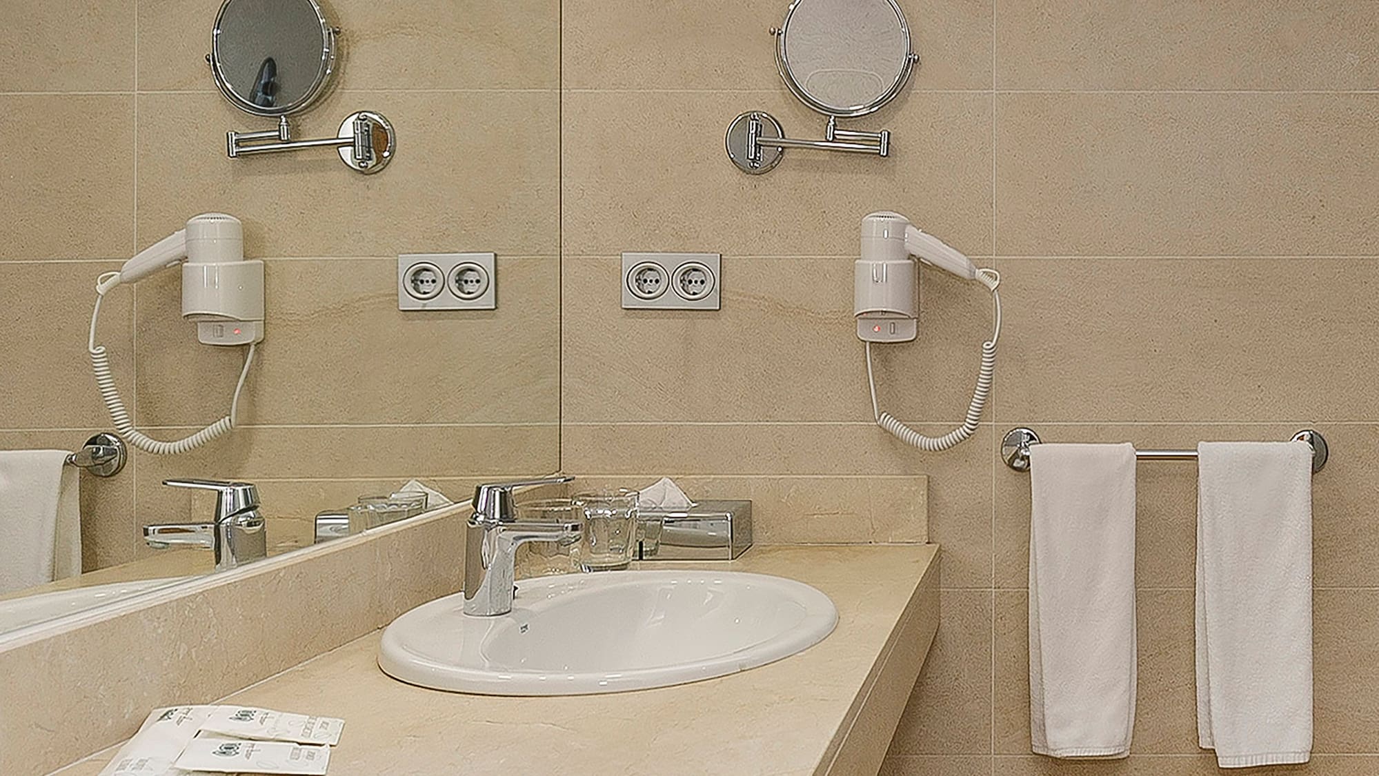 a bathroom with a sink and mirrors