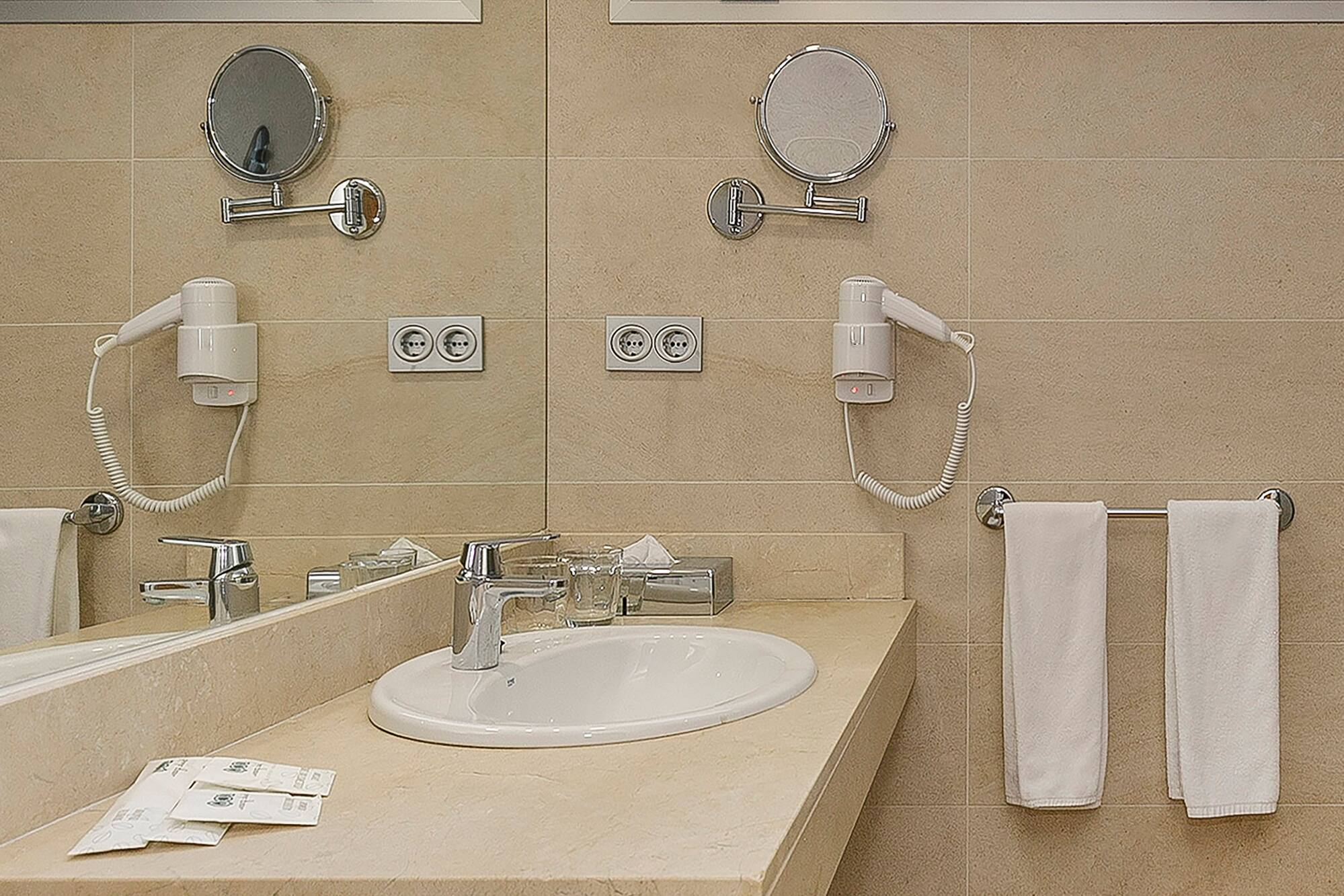 a bathroom with a sink and mirrors