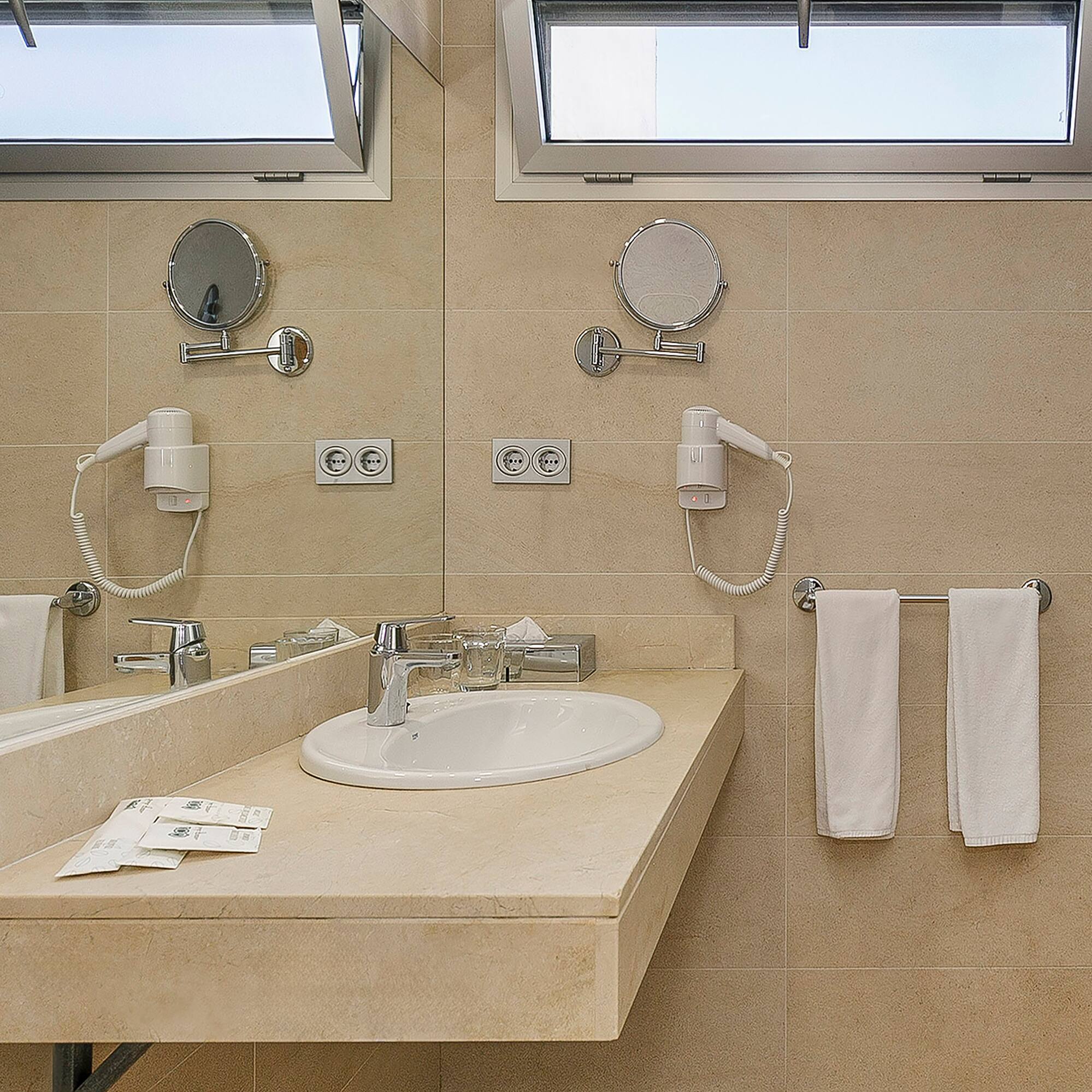a bathroom with a sink and mirrors