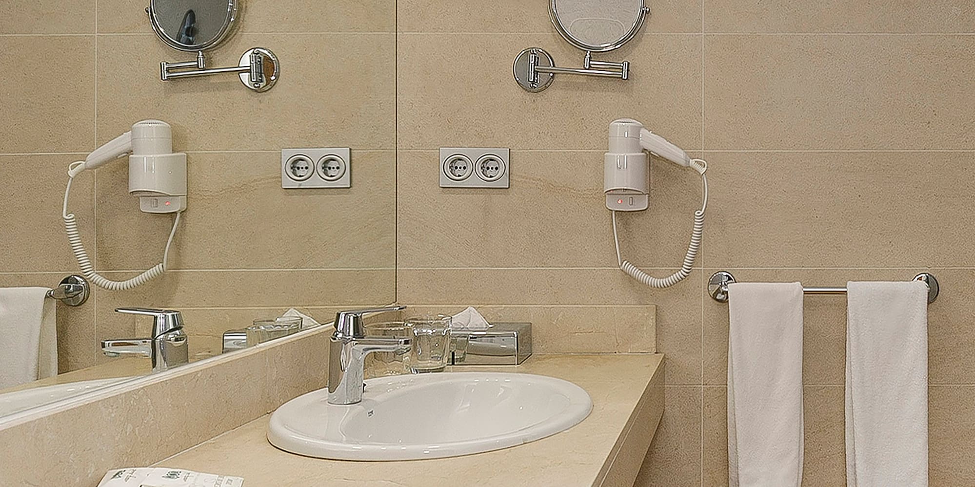 a bathroom with a sink and mirrors