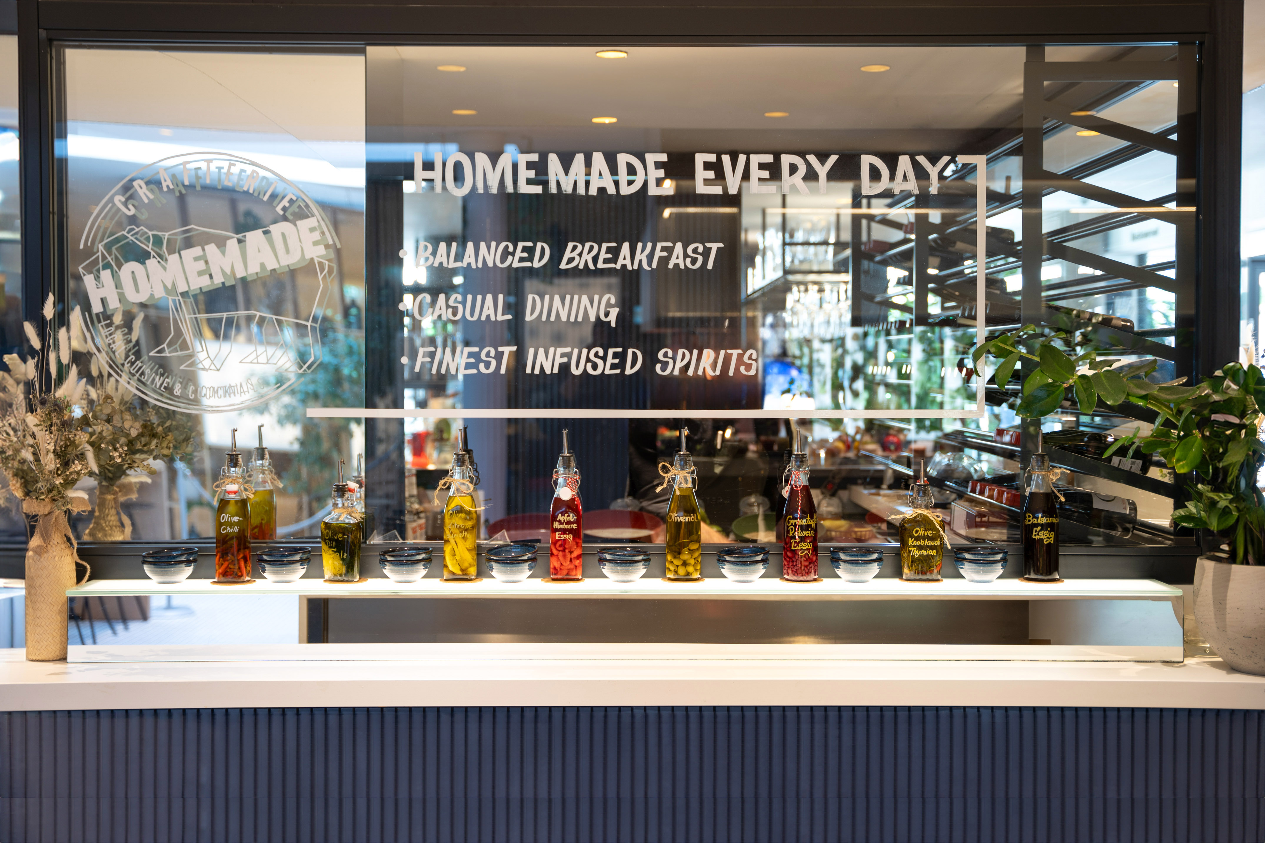Homemade Every Day restaurant window with a display of infused oils and vinegars.