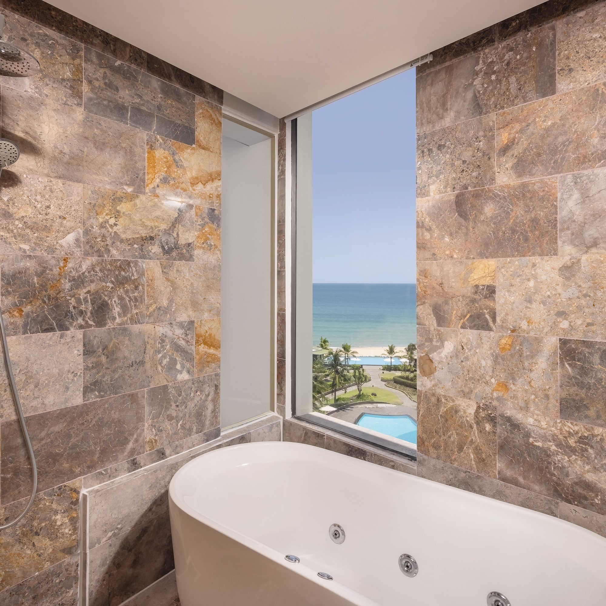 a bathroom with a bathtub and a view of the ocean