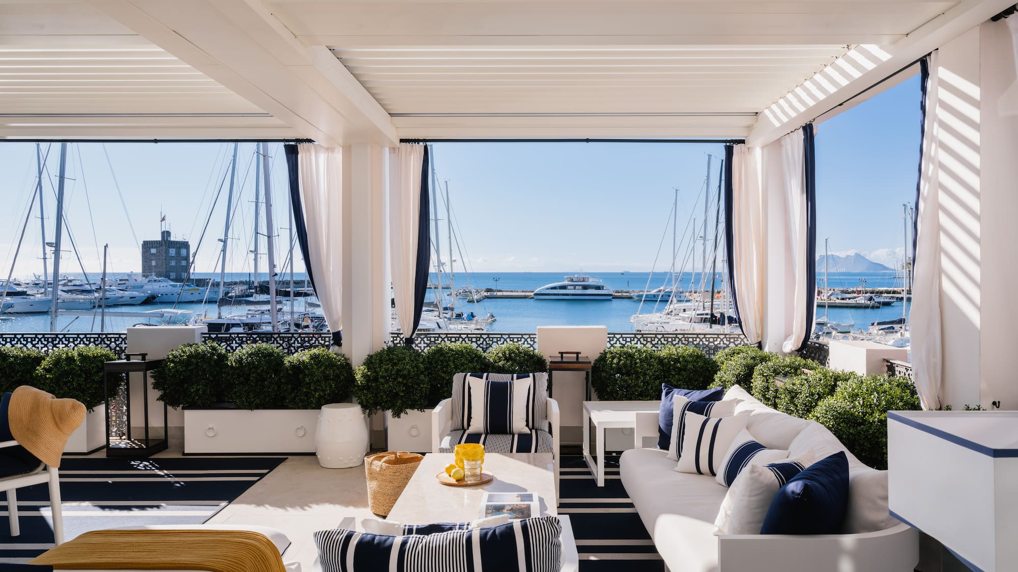 a room with a view of the water and boats