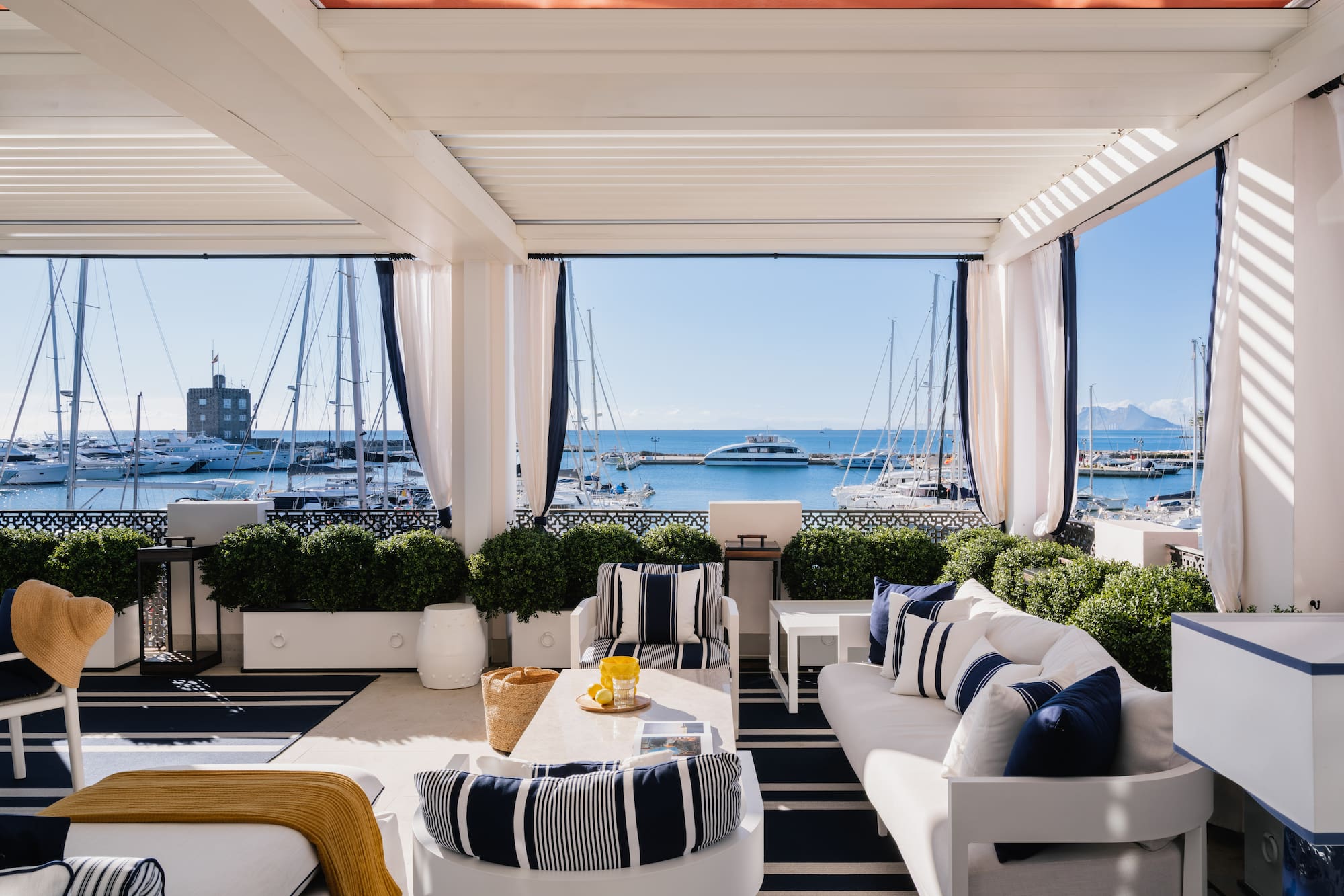 a room with a view of the water and boats