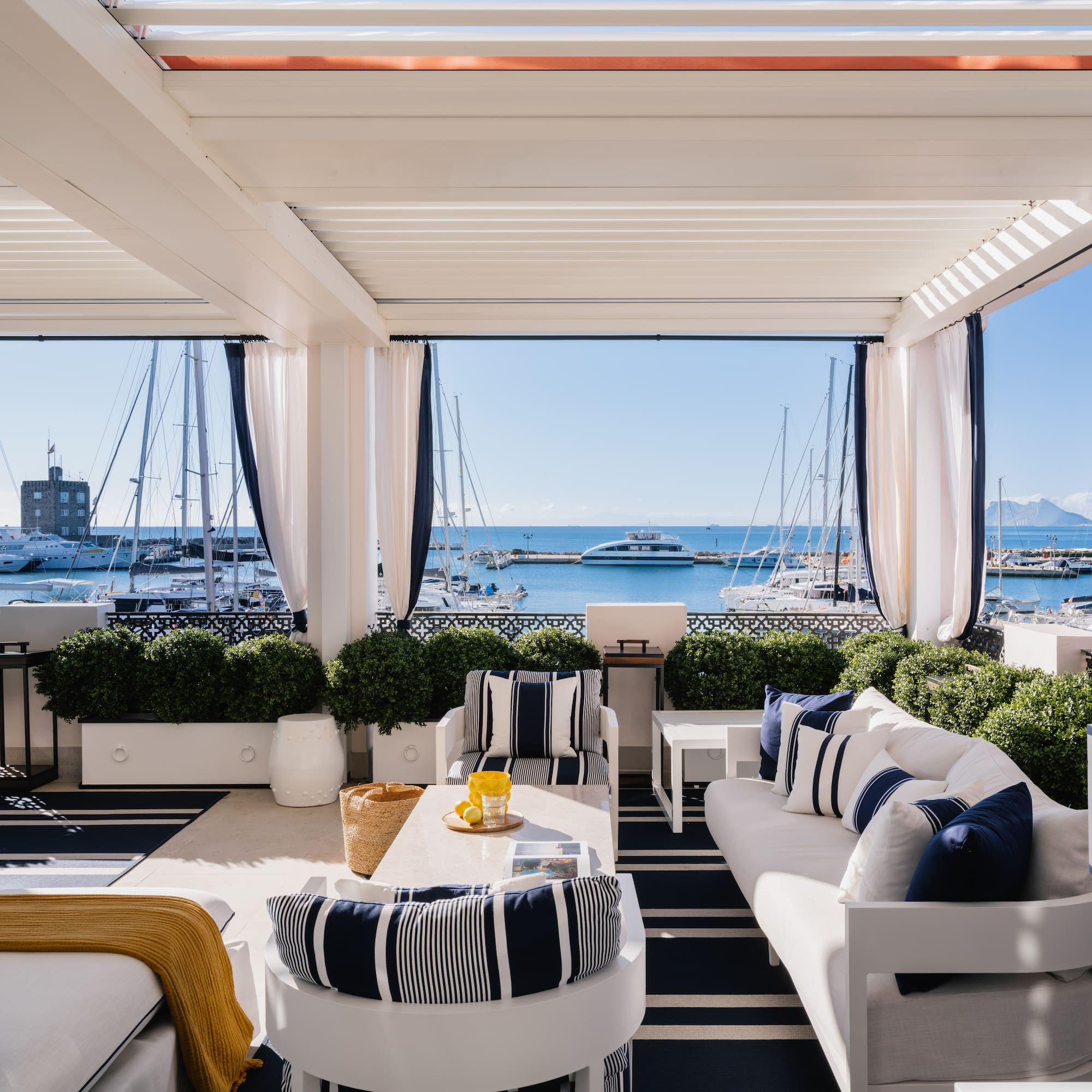 a room with a view of the water and boats
