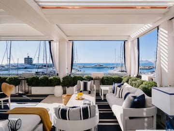 a room with a view of the water and boats