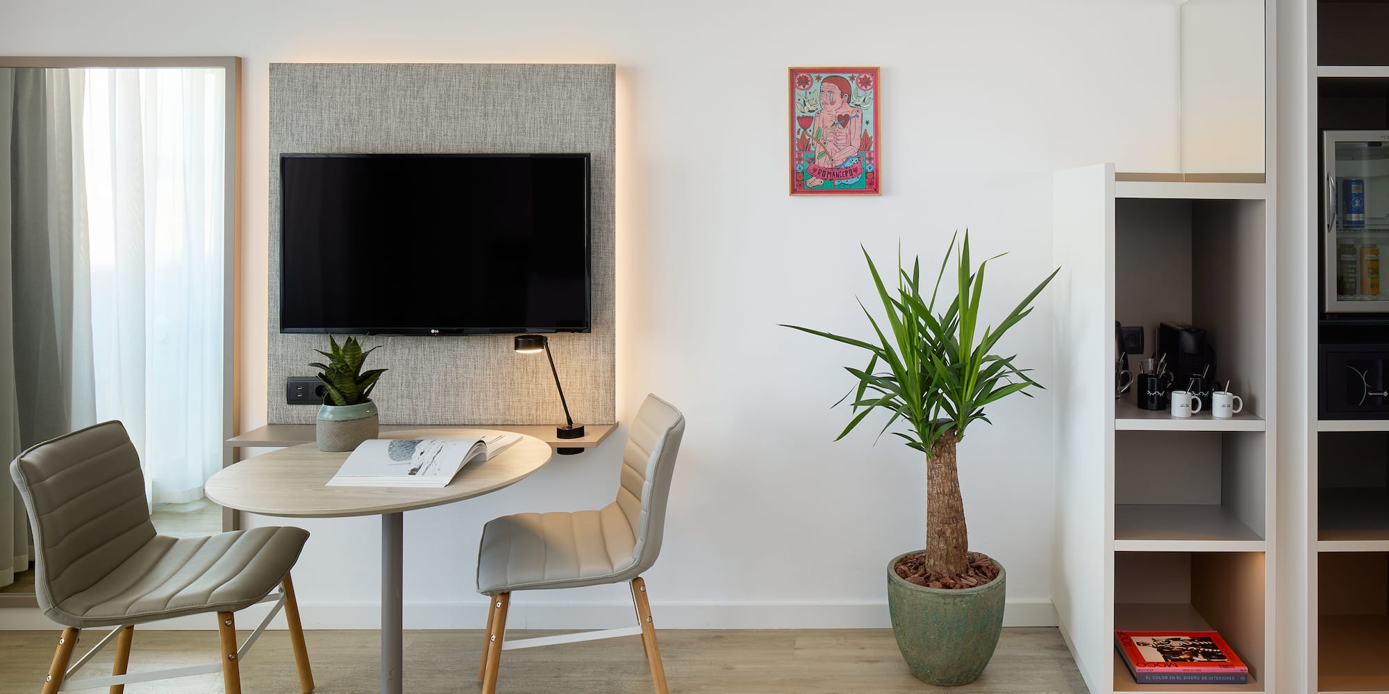 a room with a table and chairs and a tv